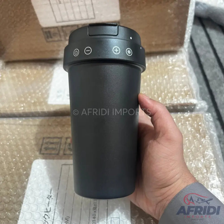 A dark gray portable electric heating mug with temperature controls.