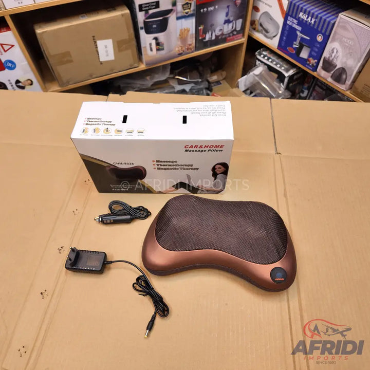 A portable brown and black massage pillow with an AC adapter and car charger.