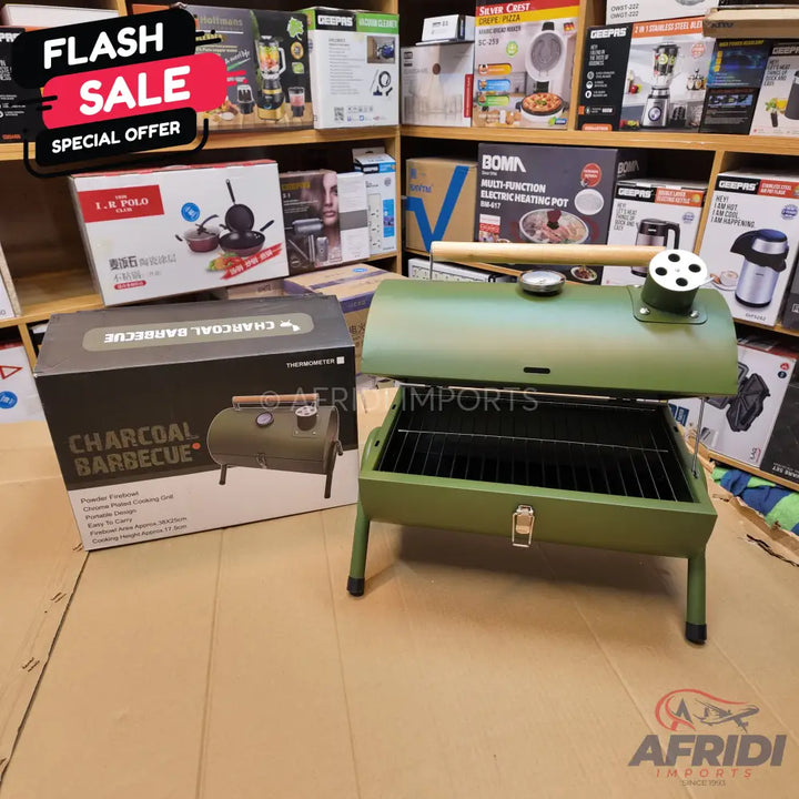 Olive green portable charcoal barbecue grill with a temperature gauge.