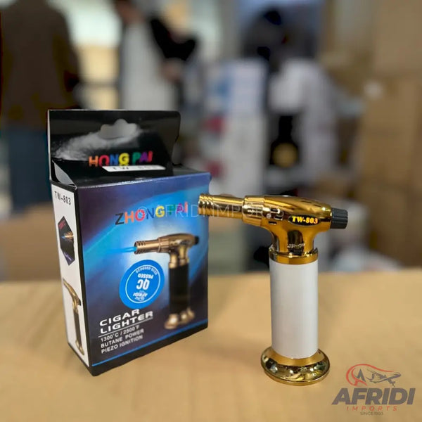 Gold and white cigar lighter with a torch flame.