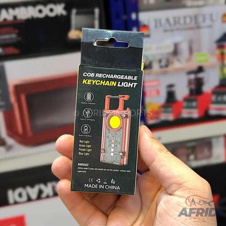A black box containing a COB rechargeable keychain light.