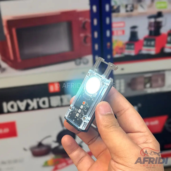 Clear, rectangular, handheld LED flashlight with a metal clip.