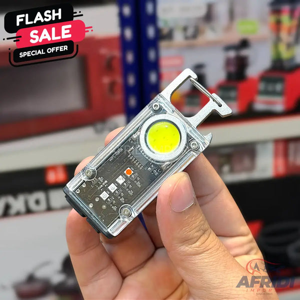 A clear plastic mini flashlight with a yellow LED and a carabiner clip.