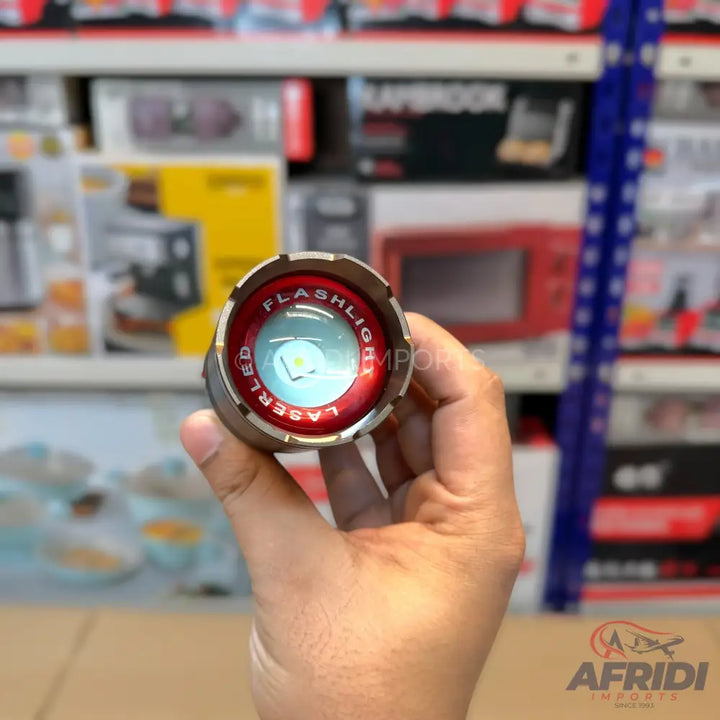 A metallic flashlight with a red bezel, featuring a central LED light and a surrounding ring labeled ’FLASHLIGHT LASER LED.’