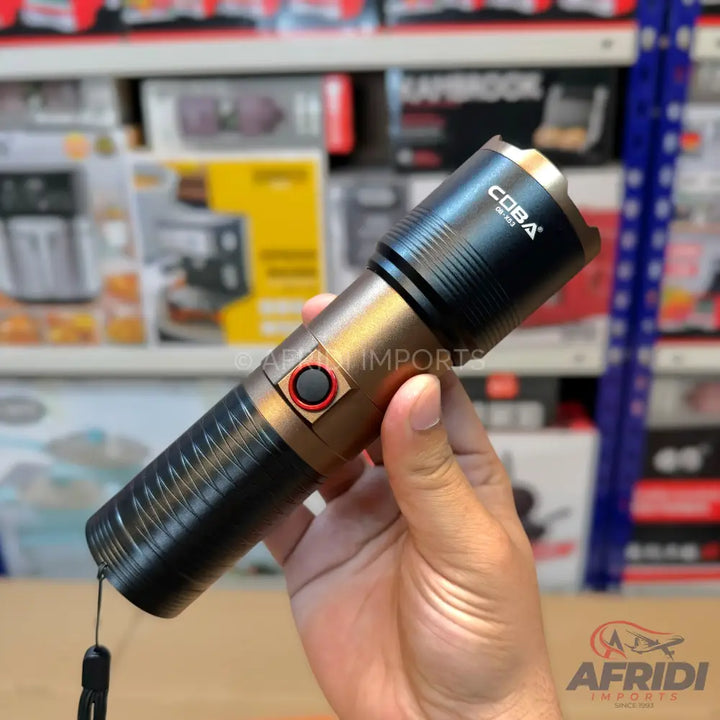 A two-toned, black and bronze flashlight with a red-ringed black power button.