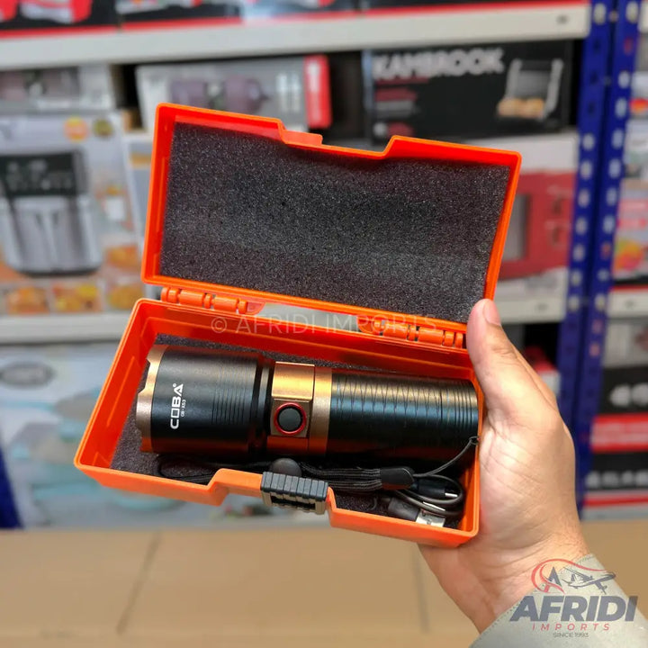 Black and gold rechargeable flashlight in an orange protective case.