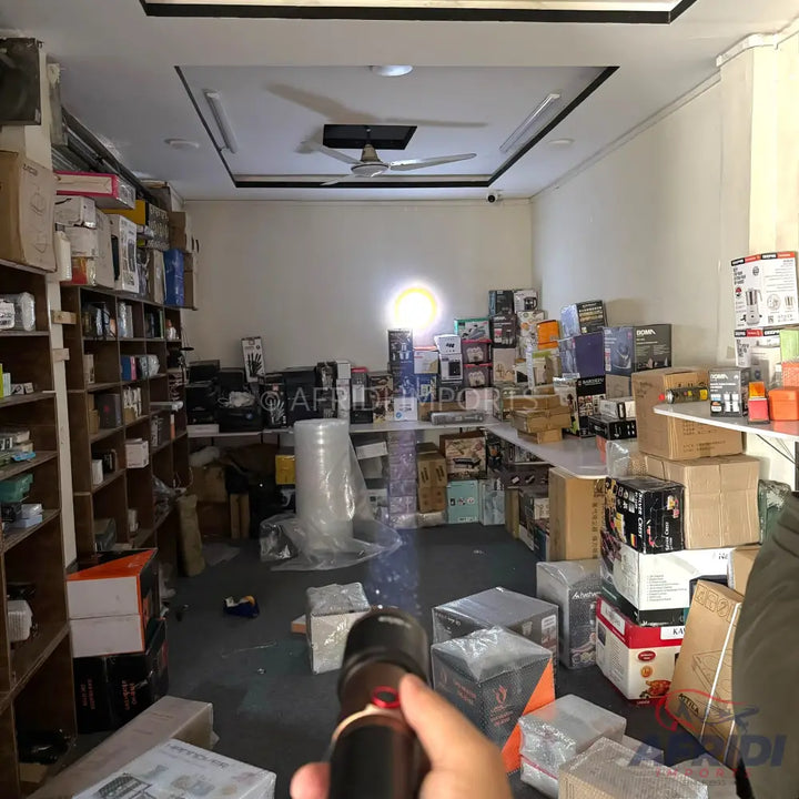 A cluttered store interior filled with shelves and stacks of boxed merchandise.