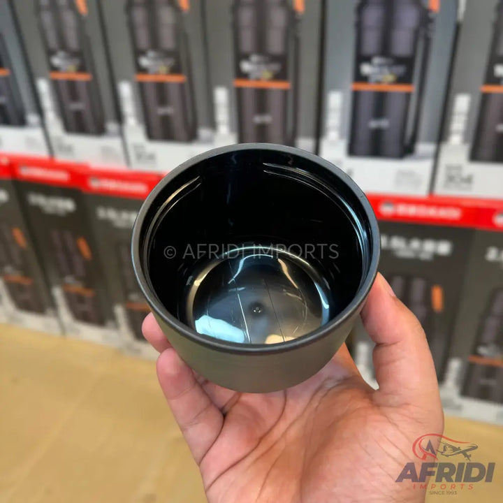 Black plastic cup held in a hand.
