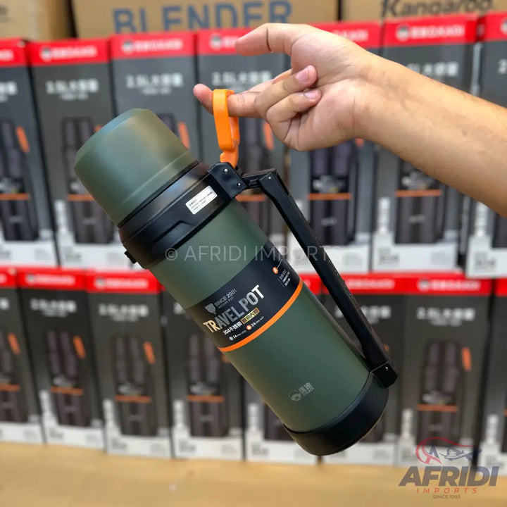 Olive green travel pot with a black handle and an orange carrying strap.