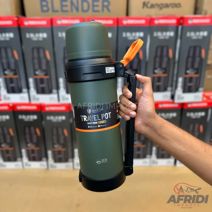 Olive green travel pot with a black handle and an orange strap.