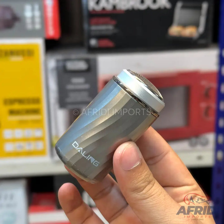 Silver compact electric shaver with a textured body.