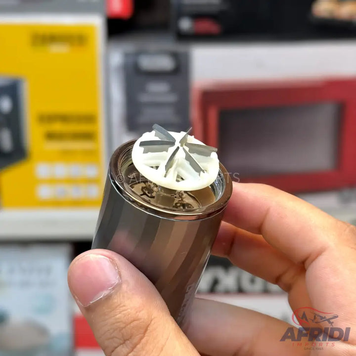 A cylindrical nose hair trimmer with a rotating blade head.