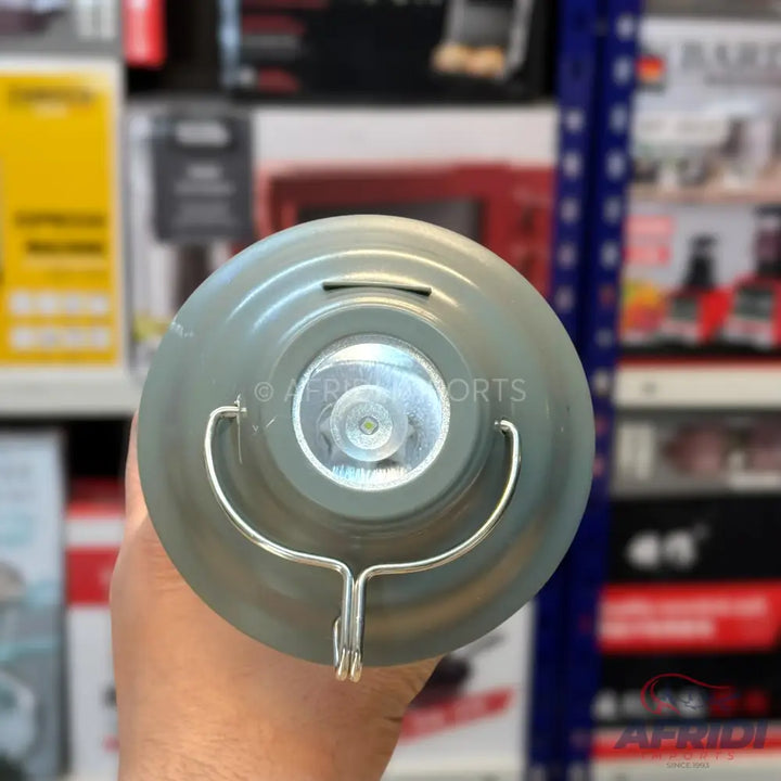 A grey portable lantern with a bright LED light and a metal hanging hook.