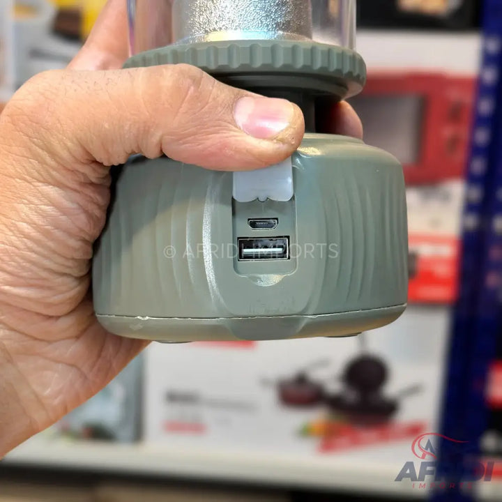A portable lantern with a USB-A output port and a micro-USB input port for charging.