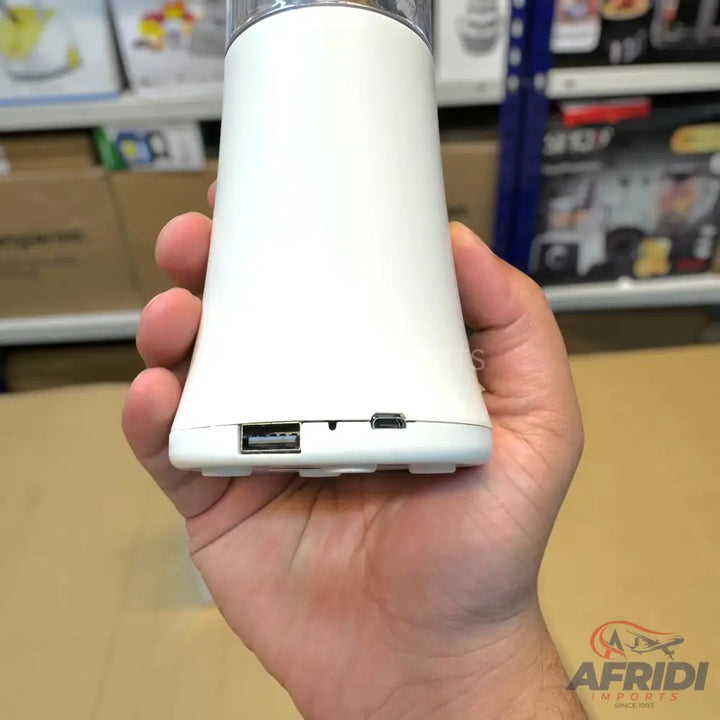 A white portable blender with USB-A and Micro-USB ports.