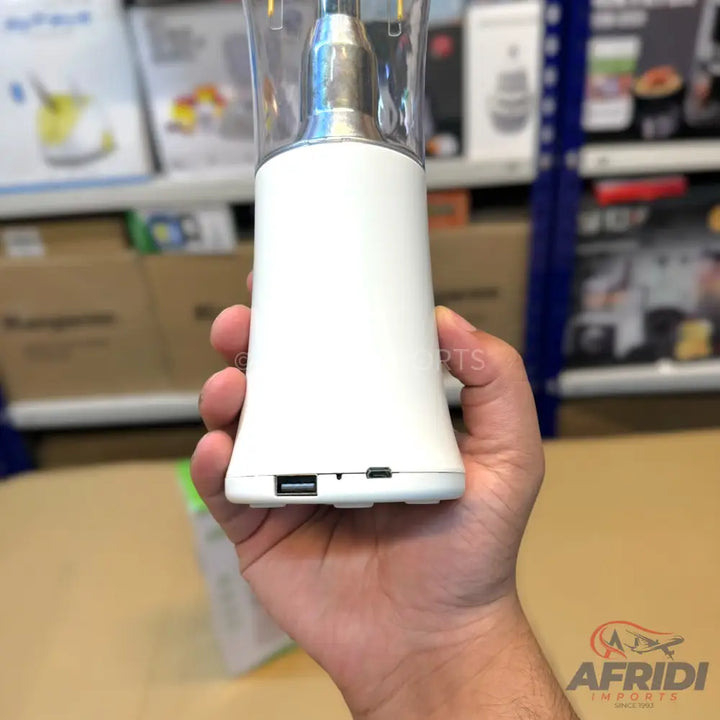 A white, portable blender with USB-A and micro-USB ports at the base.