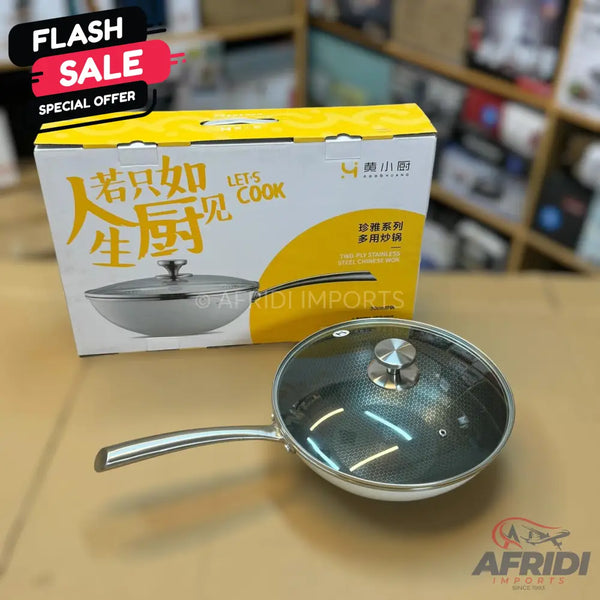 A silver frying pan with a glass lid and a matching box.