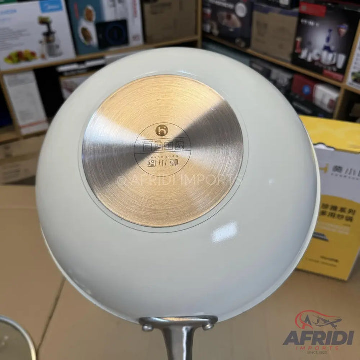 White non-stick frying pan with a metallic base.