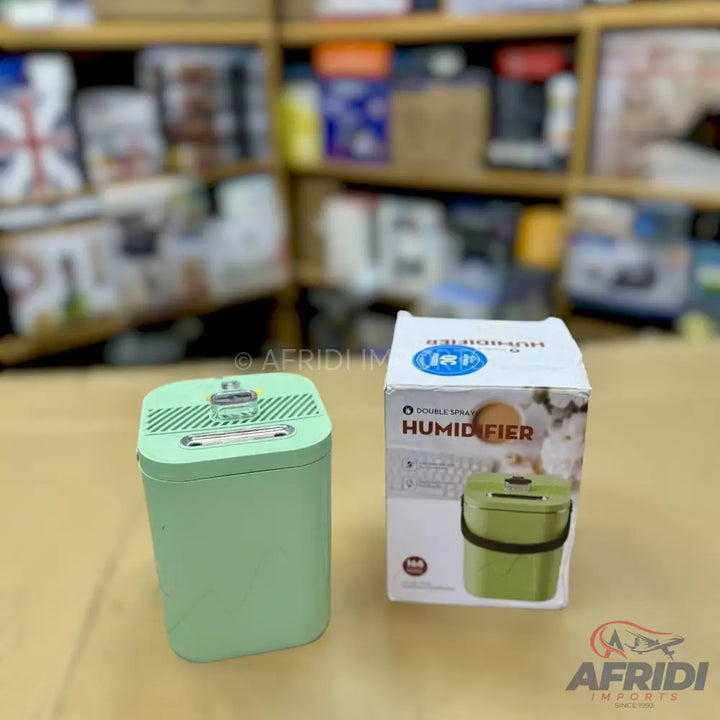A light green, rectangular-shaped humidifier with a textured top and a clear handle.