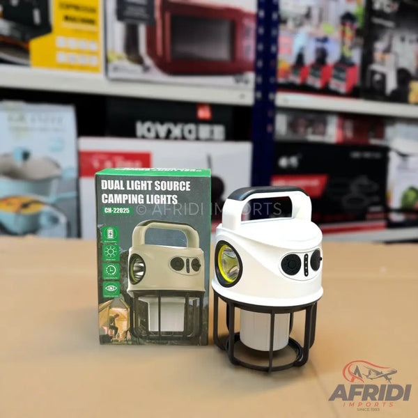 A white and black dual light source camping lantern with a handle.