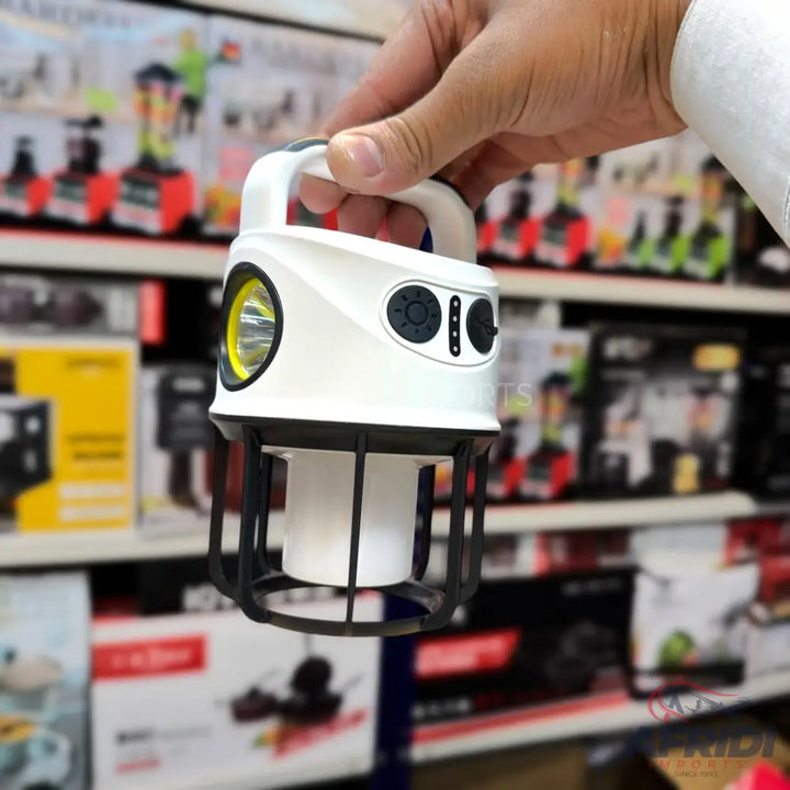 A white and black portable lantern with a handle and multiple light modes.