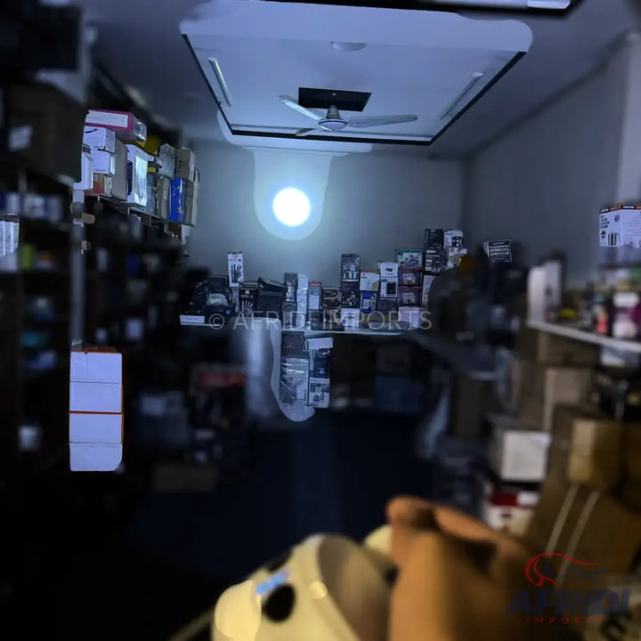 A white handheld projector casting a bright, circular image onto a wall.