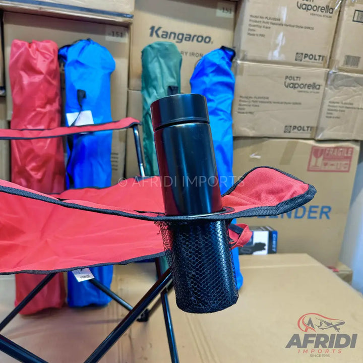 Red foldable camping chair with a black cup holder.