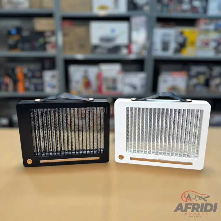 Two portable electric fan heaters, one black and one white, with top handles.