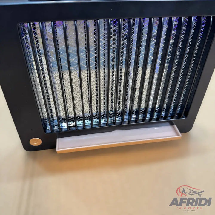 Black electric insect killer with a removable collection tray.