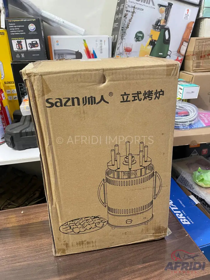 A boxed vertical electric grill with skewers.