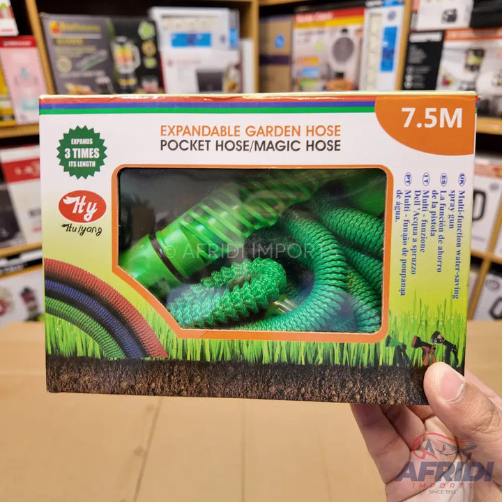Packaged expandable green garden hose with a spray gun.