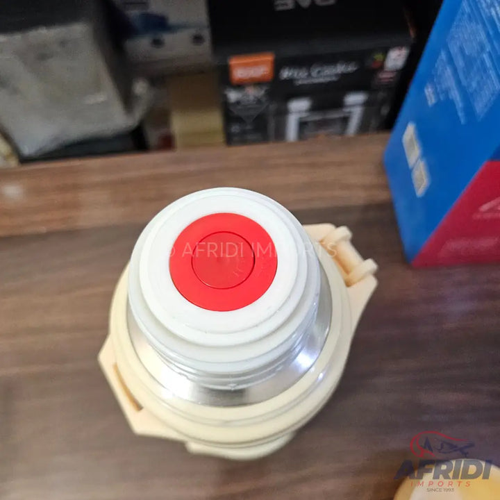 White and red thermos with a beige handle.
