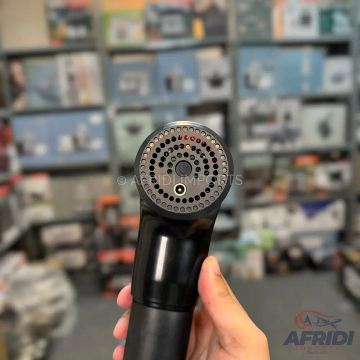 A black handheld massage gun with a circular, perforated head.