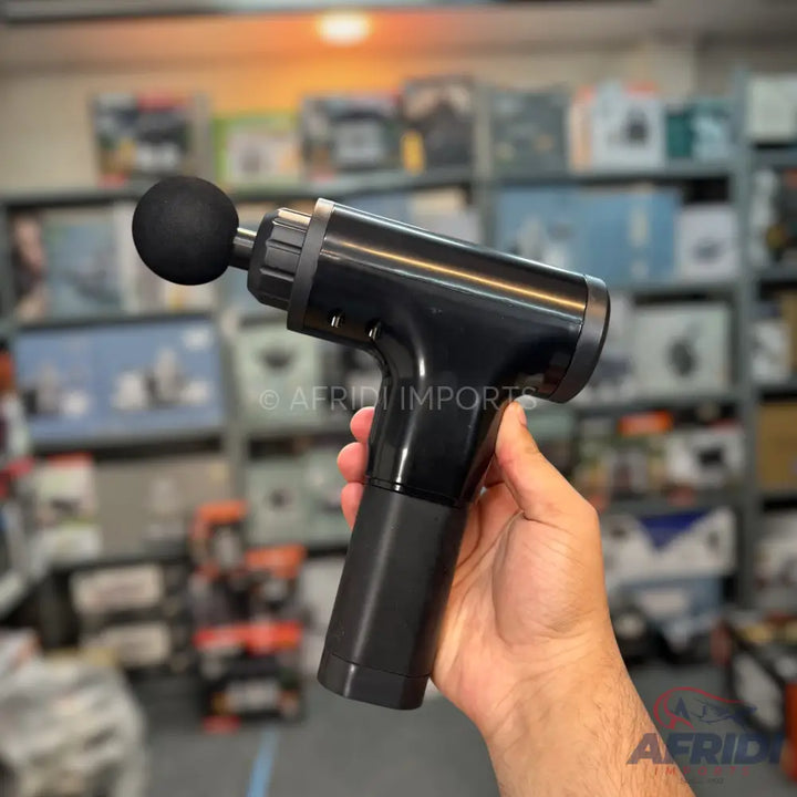 A black handheld percussive massage gun with a spherical attachment.