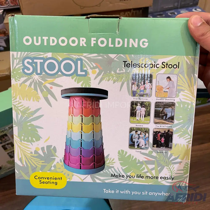 A packaged collapsible outdoor folding stool with a colorful, telescoping design.