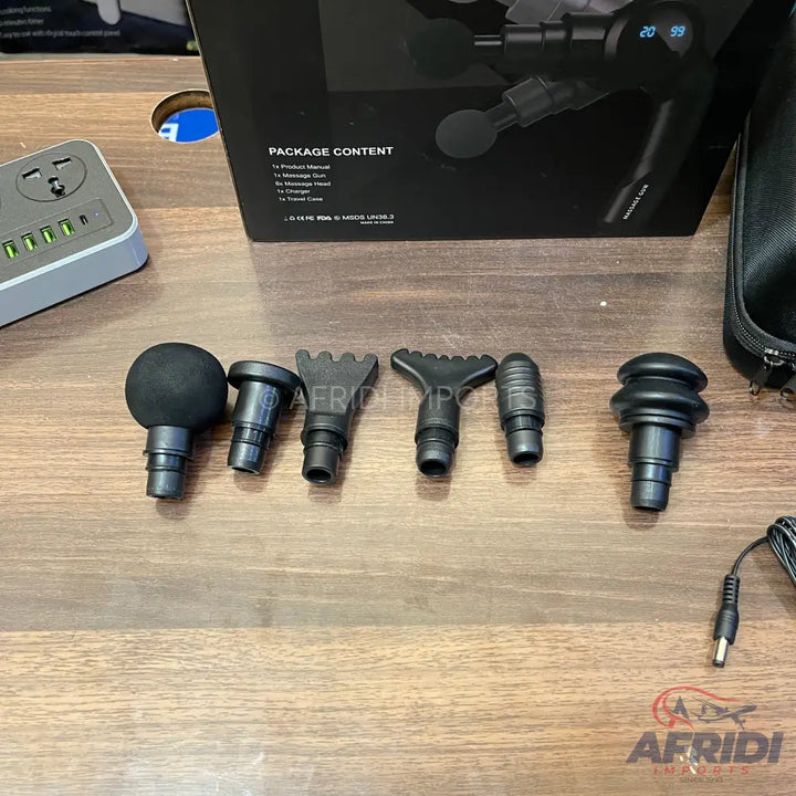 A percussive massage gun with six interchangeable head attachments.