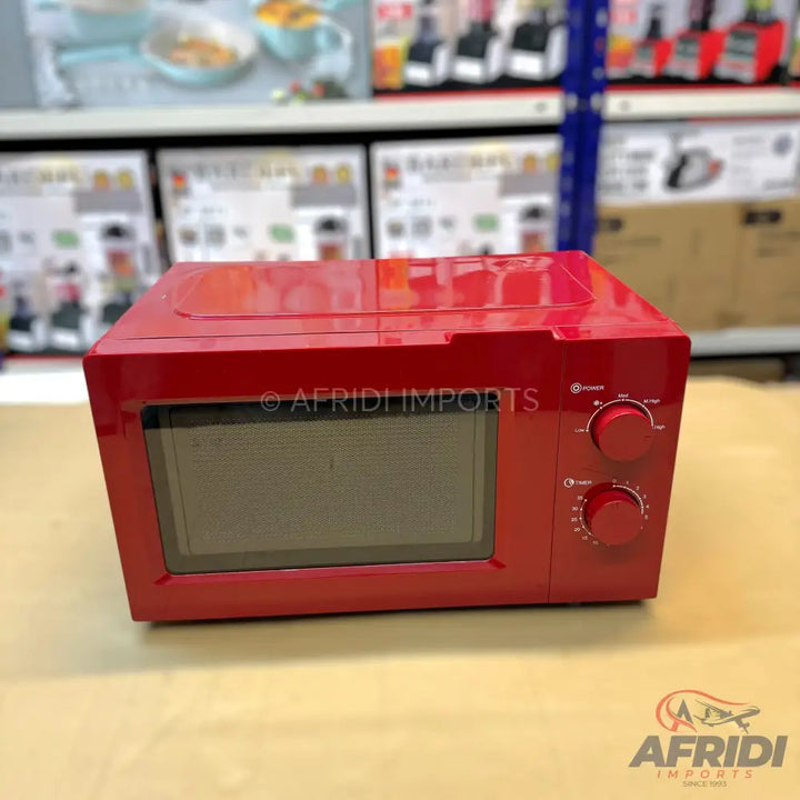 Red countertop microwave oven with two control knobs.