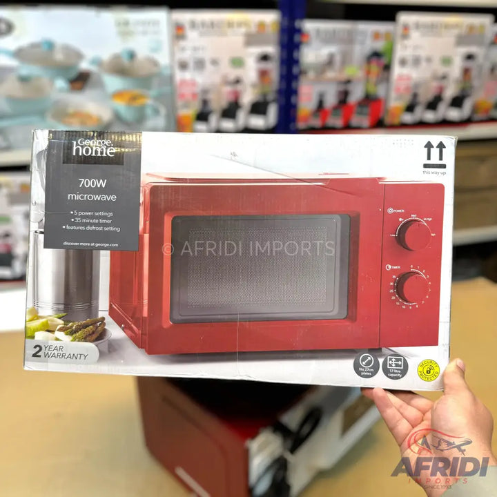 Red 700W microwave oven with 5 power settings, a 30-minute timer, and a defrost setting, carrying a 2-year warranty.