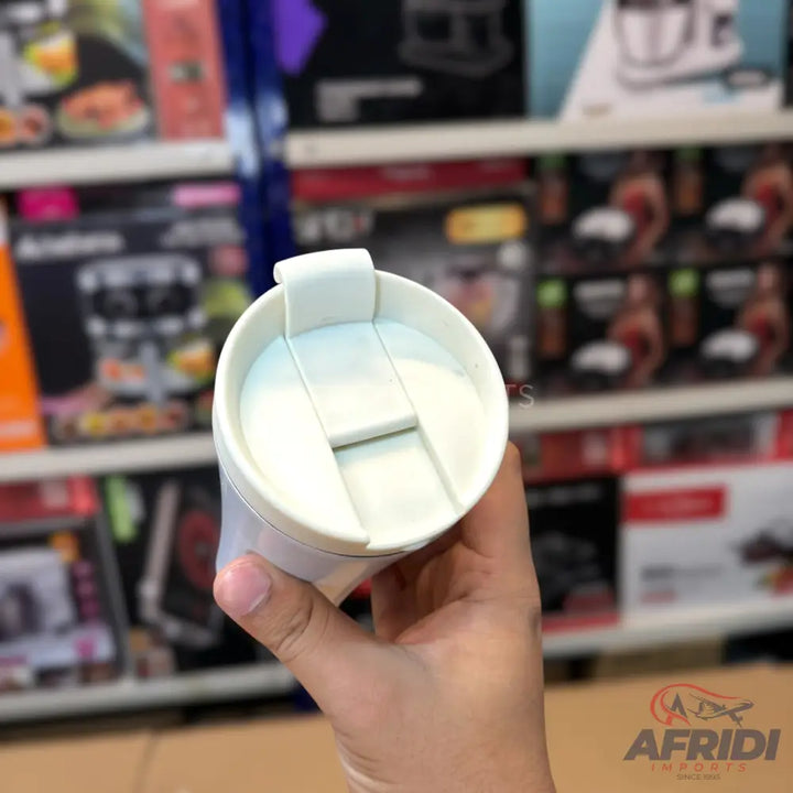 White travel mug with a flip-top lid.