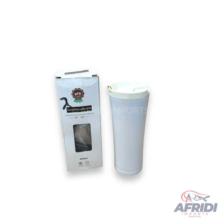 White insulated travel mug with a matching white lid, accompanied by its product packaging.