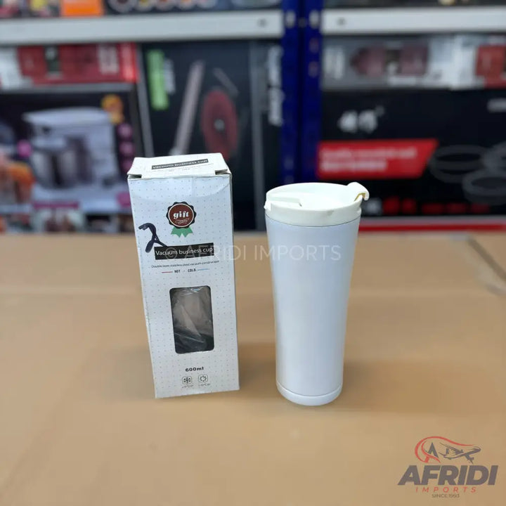 White, lidded, insulated travel mug with a matching box.