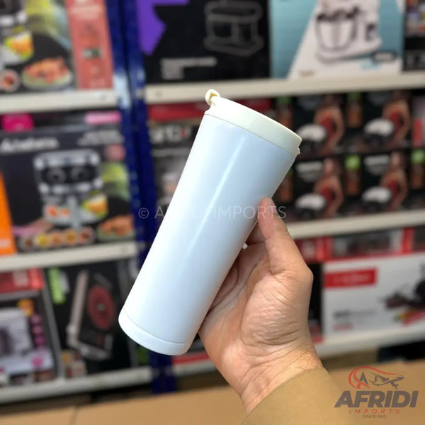 White cylindrical water filter cartridge held in a hand.