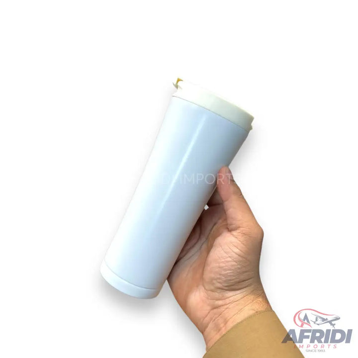 A person holding a white, cylindrical, insulated tumbler with a white lid.