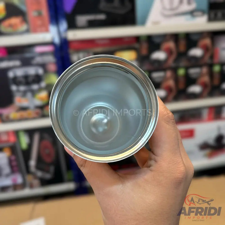 An empty, clean, silver-colored metal travel mug or tumbler, viewed from above, showing its interior.