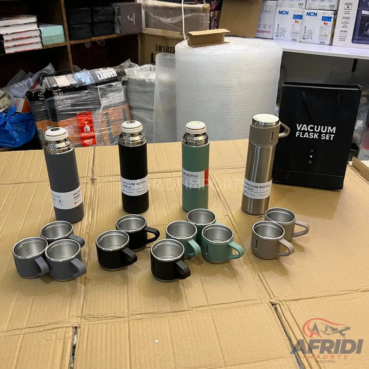 Assorted vacuum flask sets with matching cups.