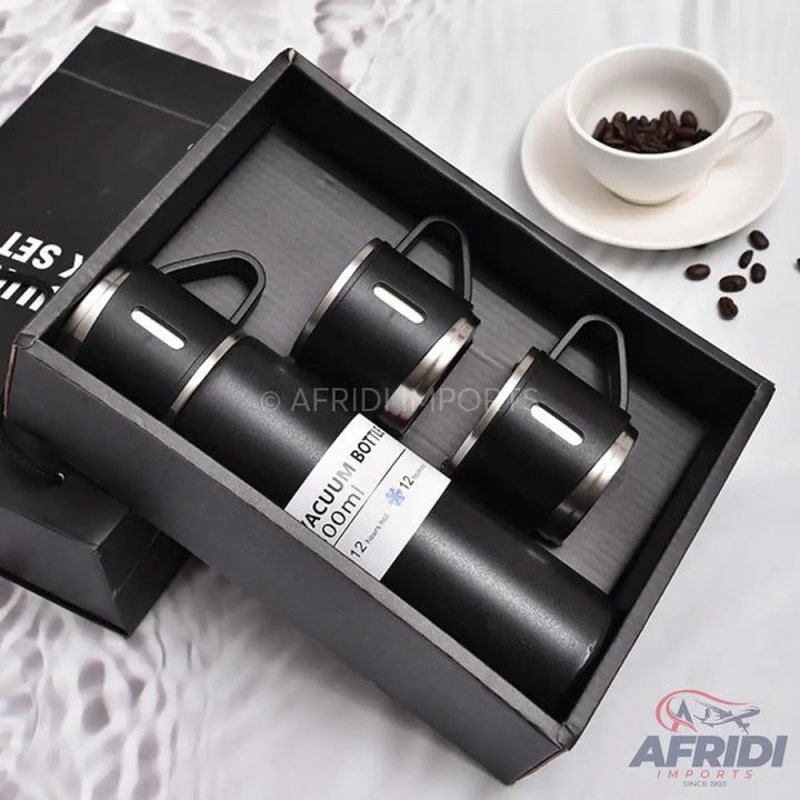 Black vacuum bottle and three matching cups in a gift box.