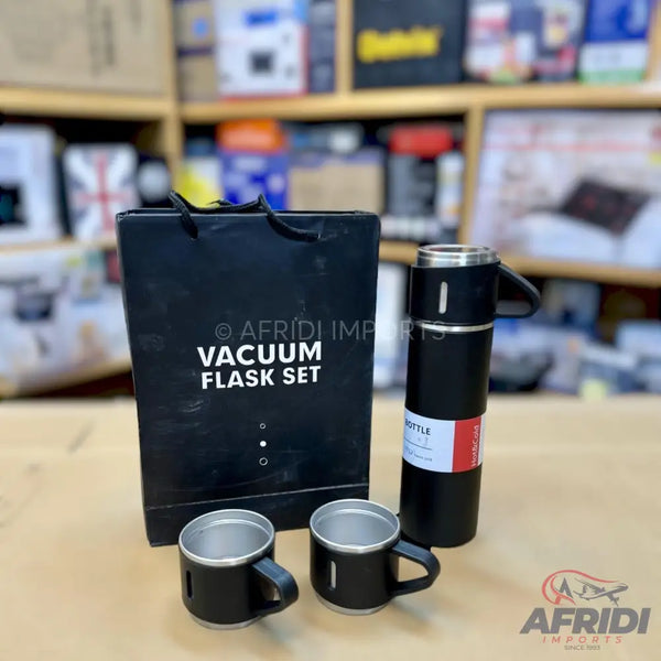 A black vacuum flask set with two matching cups.