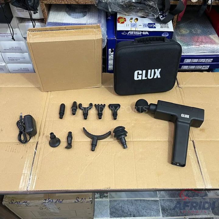 Black percussive massage gun with various interchangeable head attachments and a carrying case.