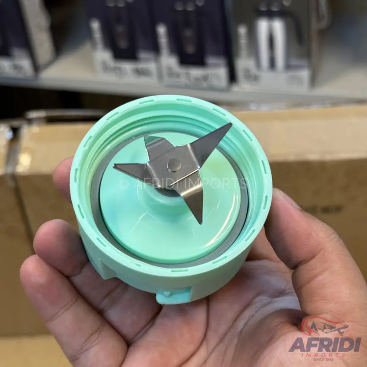 A portable blender base with a four-blade assembly.