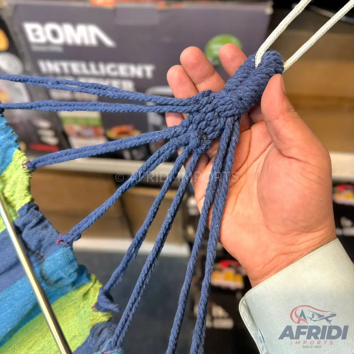 Blue woven ropes of a hammock being held.